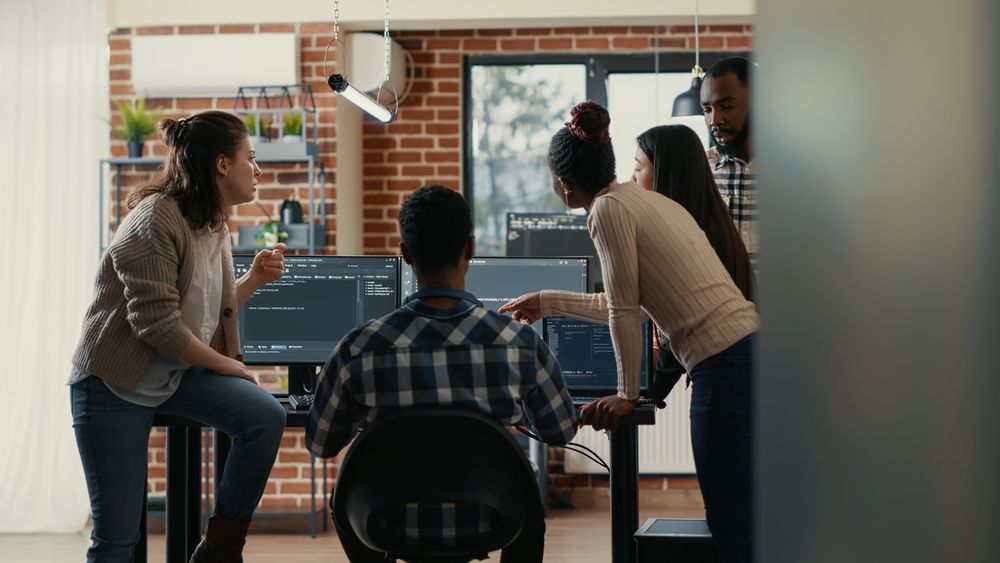 coders-discussing-about-source-code-compiling-discovers-errors-asks-rest-team-explanations-front-multiple-screens-running-algorithms-software-developers-doing-teamwork (1).jpg