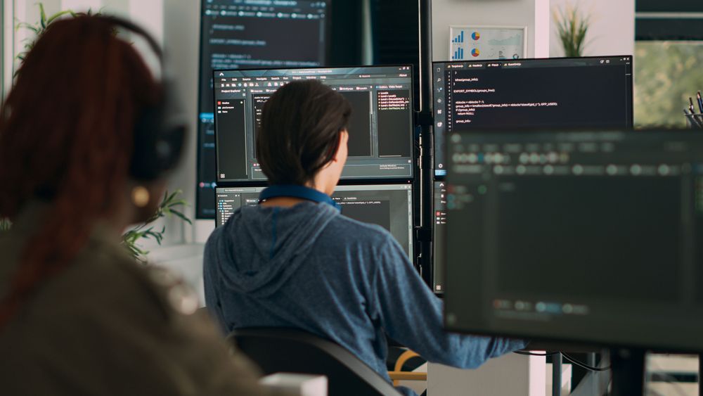 database-programer-writing-code-terminal-window-using-multiple-monitors-it-agency-office-system-software-developer-typing-database-information-computing-big-data-script.jpg