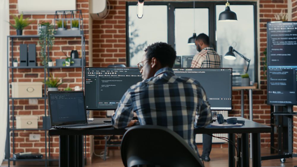 programer-coding-laptop-sitting-down-desk-with-computer-screens-parsing-code-software-agency-software-developer-compiling-algorithms-with-cloud-programers-working-background.jpg